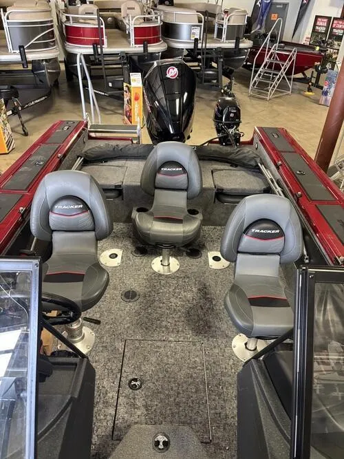 Slide: The Image of 2025 Tracker Targa V-19 Combo boat seat with steering wheel, gray upholstery. - 5