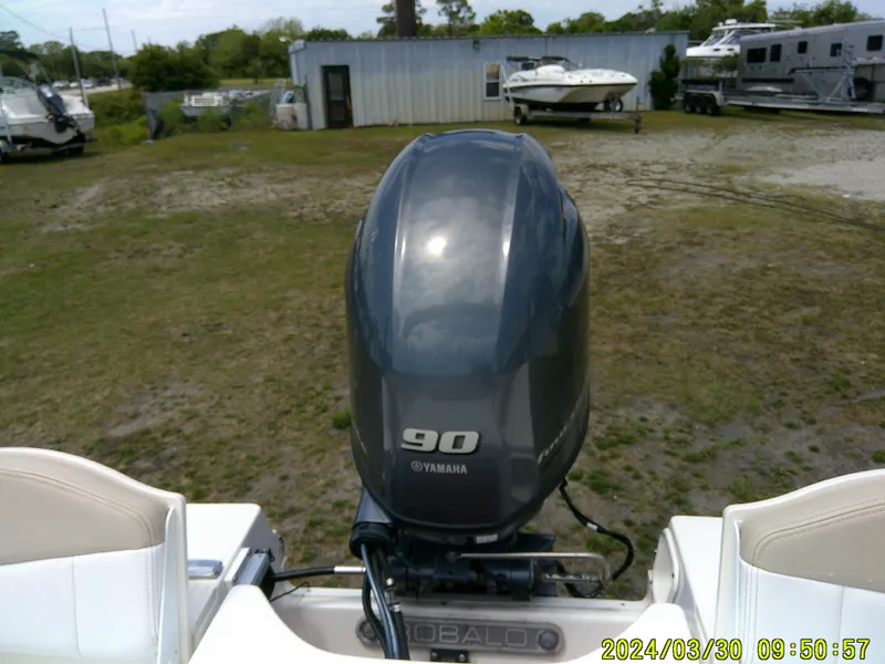 Slide: The Image of 2018 Robalo R160 cc boat with Yamaha 90 engine in outdoor storage area. - 18