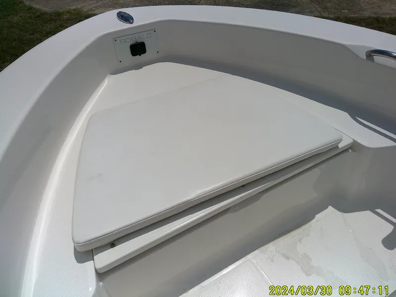 Slide: The Image of 2018 Robalo R160 cc boat bow seating area with storage compartment. - 7