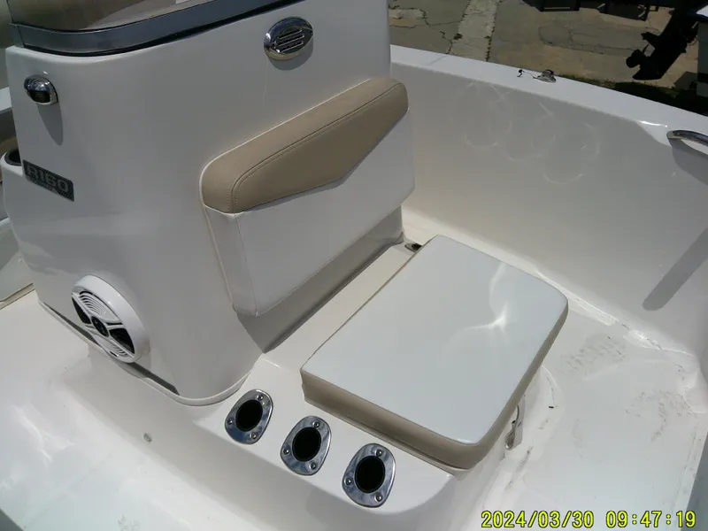 Slide: The Image of 2018 Robalo R160 cc boat interior with seating and rod holders. - 8