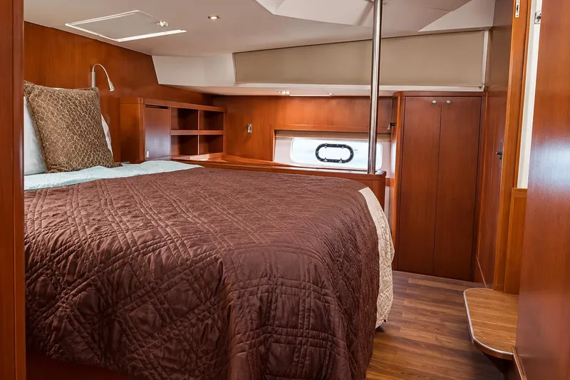 Slide: The Image of Luxurious cabin interior of 2016 Aquila 44 Yacht with wooden furnishings and cozy bedding. - 13