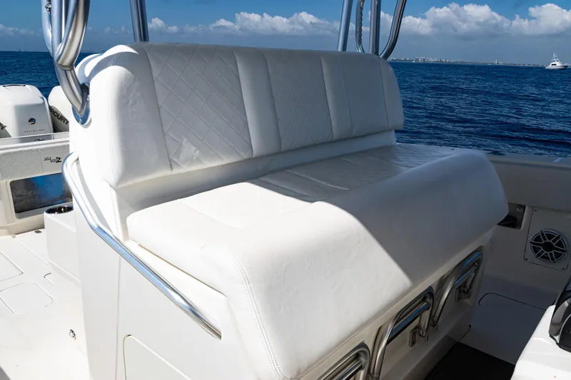 Slide: The Image of 2019 SeaVee 390Z boat with white cushioned seating, ocean view in background. - 10