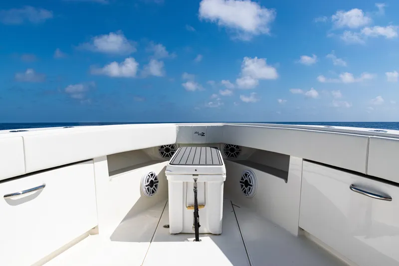 Slide: The Image of 2019 SeaVee 390Z boat deck with storage, speakers, and ocean view under blue sky. - 16
