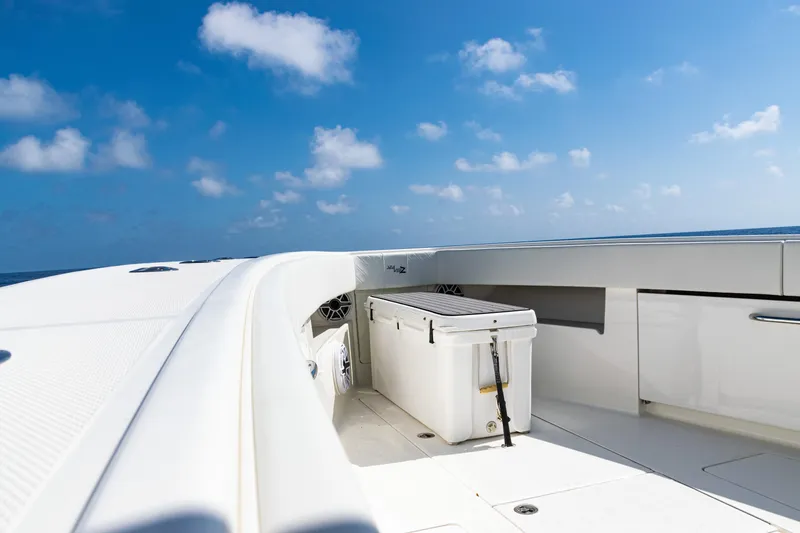 Slide: The Image of 2019 SeaVee 390Z boat deck with cooler under clear blue sky. - 18
