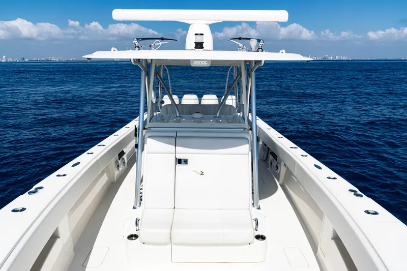 Slide: The Image of 2019 SeaVee 390Z boat on open ocean, clear sky, and distant city skyline. - 21