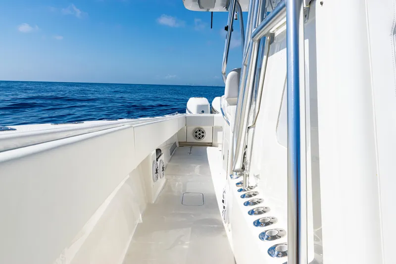 Slide: The Image of 2019 SeaVee 390Z boat deck with ocean view, featuring sleek design and stainless steel fixtures. - 26