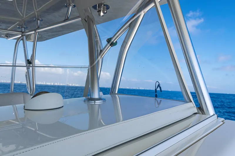 Slide: The Image of 2019 SeaVee 390Z boat with sleek design, ocean view, and clear blue sky. - 28