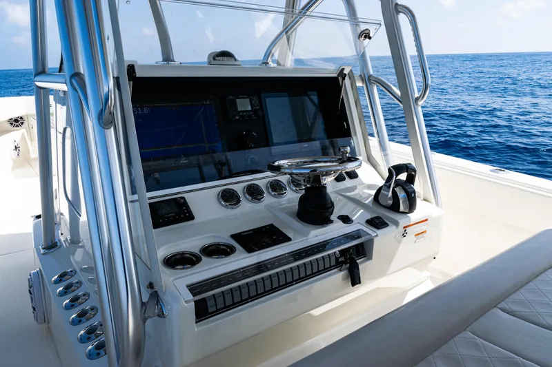 Slide: The Image of 2019 SeaVee 390Z boat console with navigation equipment, steering wheel, and ocean view. - 30