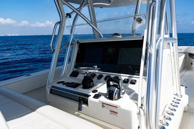 Slide: The Image of 2019 SeaVee 390Z boat console with ocean view, featuring modern navigation equipment. - 32