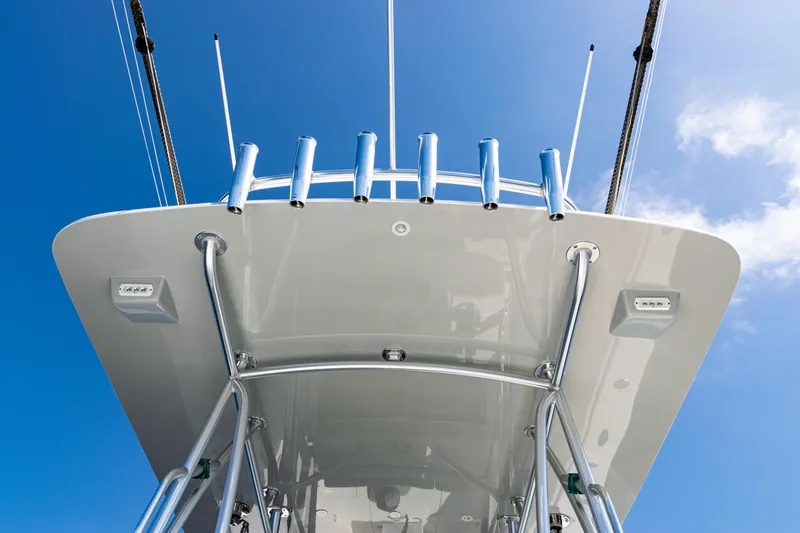 Slide: The Image of 2019 SeaVee 390Z boat's T-top with rod holders against a clear blue sky. - 34