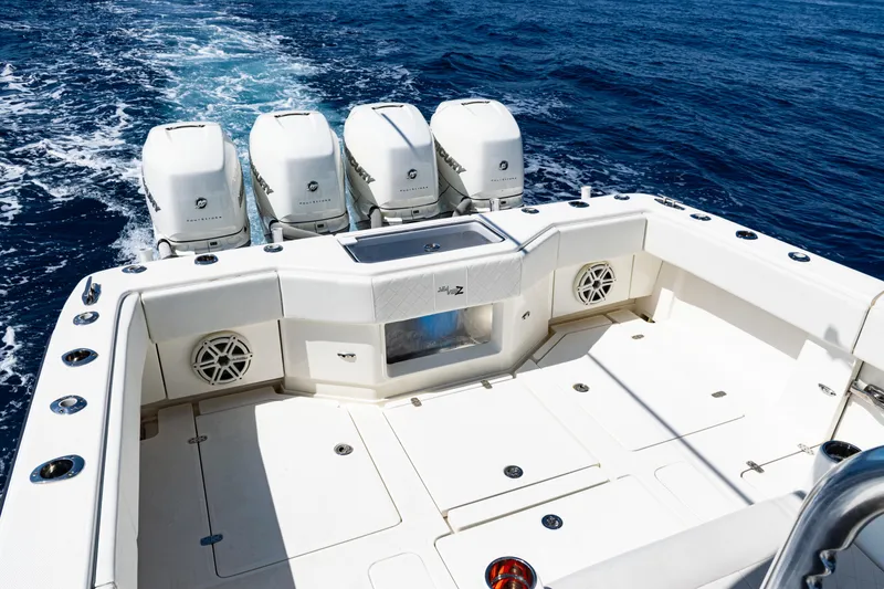 Slide: The Image of 2019 SeaVee 390Z boat with quad engines, spacious deck, and ocean backdrop. - 36