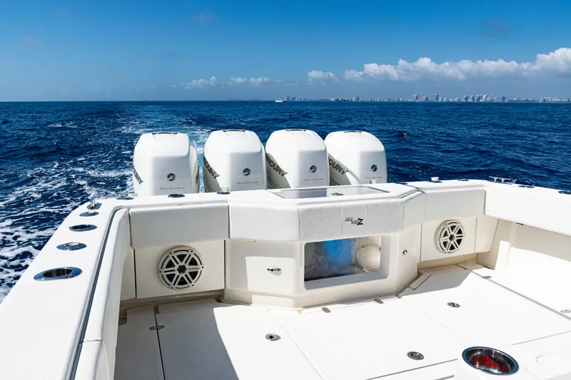 Slide: The Image of 2019 SeaVee 390Z boat with four engines cruising on open ocean under clear blue sky. - 43