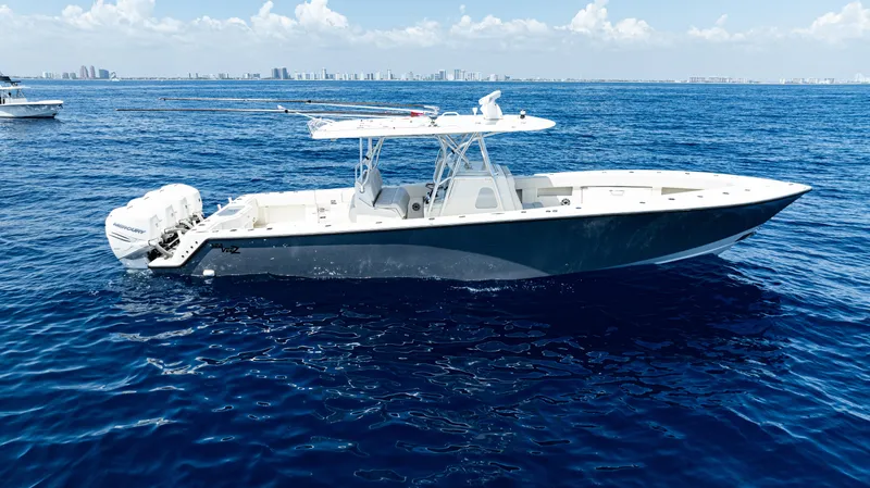 Slide: The Image of 2019 SeaVee 390Z boat on open ocean, clear sky, distant city skyline. - 46