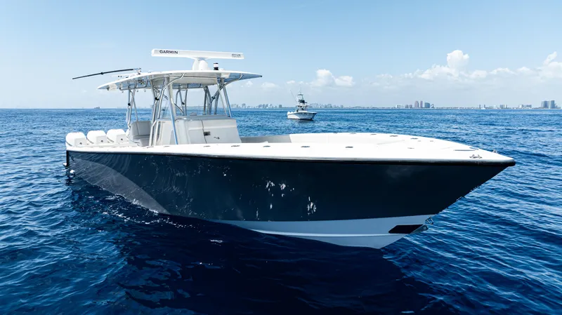 Slide: The Image of 2019 SeaVee 390Z boat cruising on open ocean under clear blue sky. - 47