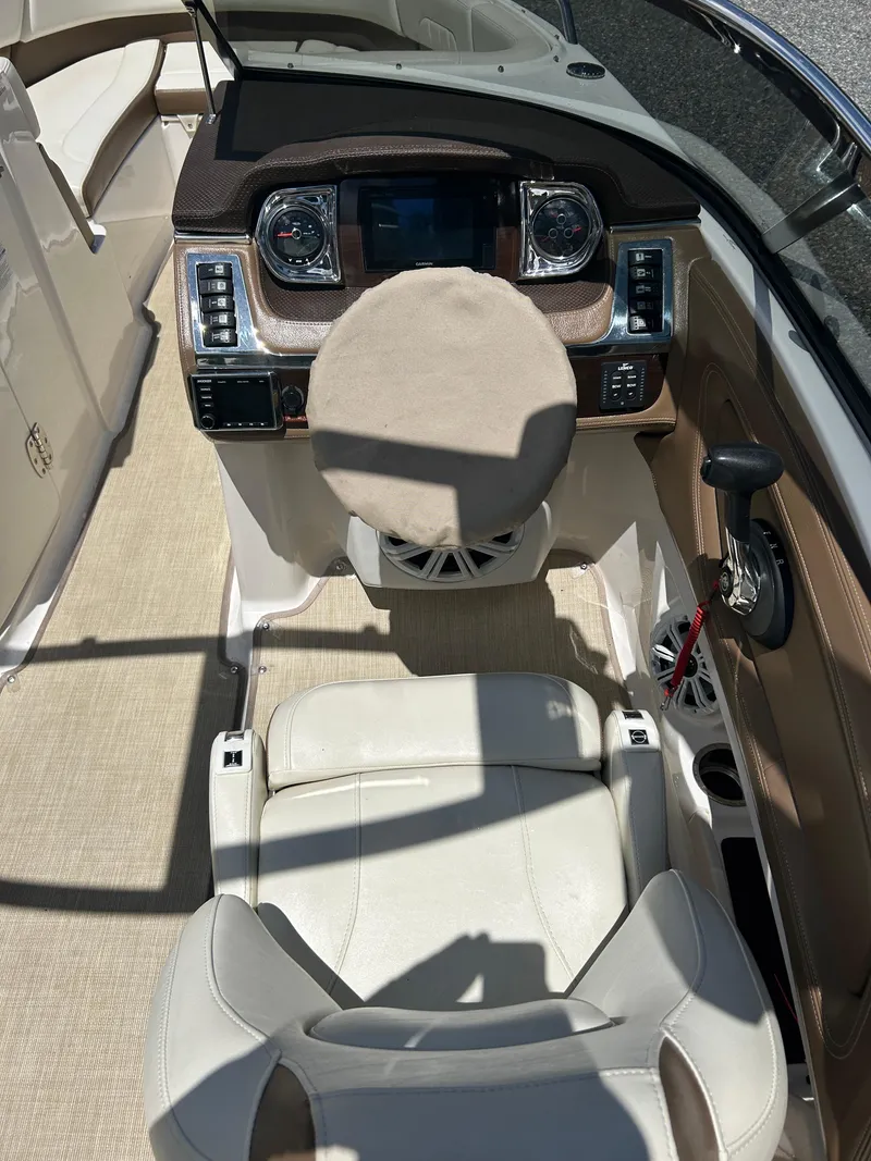 Slide: The Image of 2016 Chaparral 257 SSX boat interior with steering wheel and dashboard controls. - 12