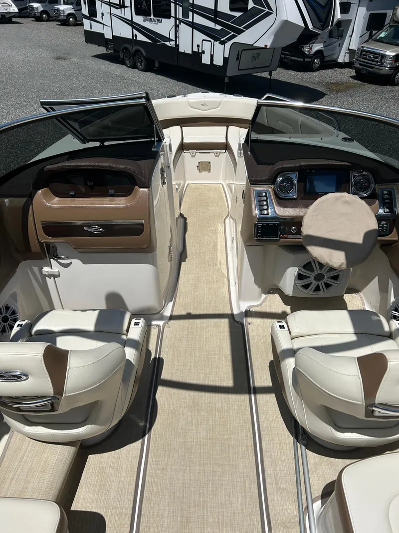 Slide: The Image of 2016 Chaparral 257 SSX boat interior with beige seating and modern dashboard. - 13
