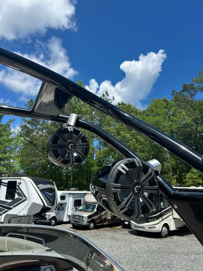Slide: The Image of 2016 Chaparral 257 SSX boat speakers against a clear blue sky and RVs in the background. - 14
