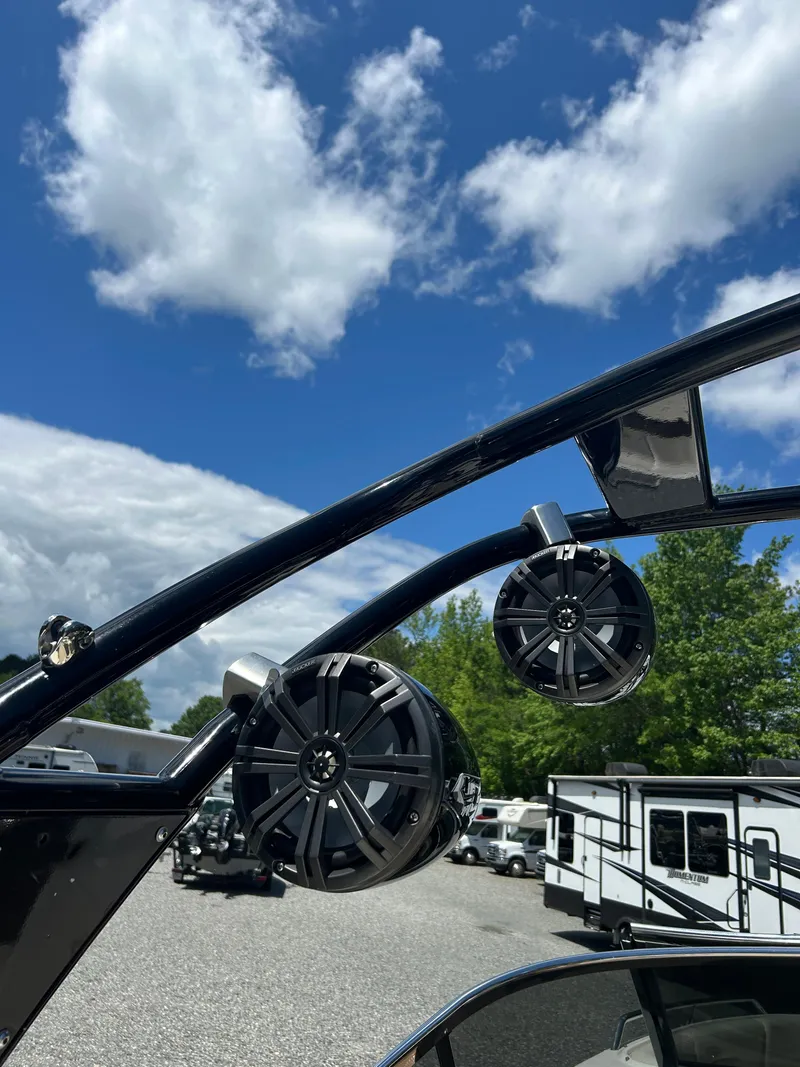 Slide: The Image of Speakers on a 2016 Chaparral 257 SSX boat against a cloudy blue sky. - 15