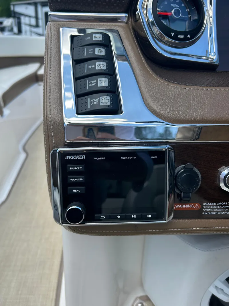Slide: The Image of 2016 Chaparral 257 SSX boat dashboard with Kicker stereo system and control panel. - 17