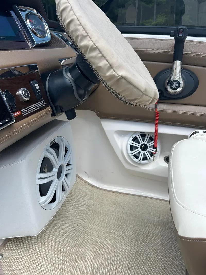 Slide: The Image of Interior of 2016 Chaparral 257 SSX boat with steering wheel and speaker system. - 18