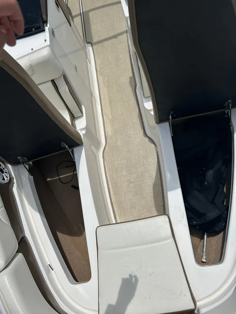 Slide: The Image of 2016 Chaparral 257 SSX boat interior with seating and storage compartments. - 21