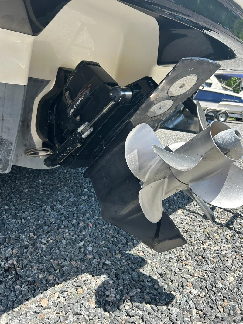 Slide: The Image of 2016 Chaparral 257 SSX boat propeller and outdrive on gravel surface. - 5