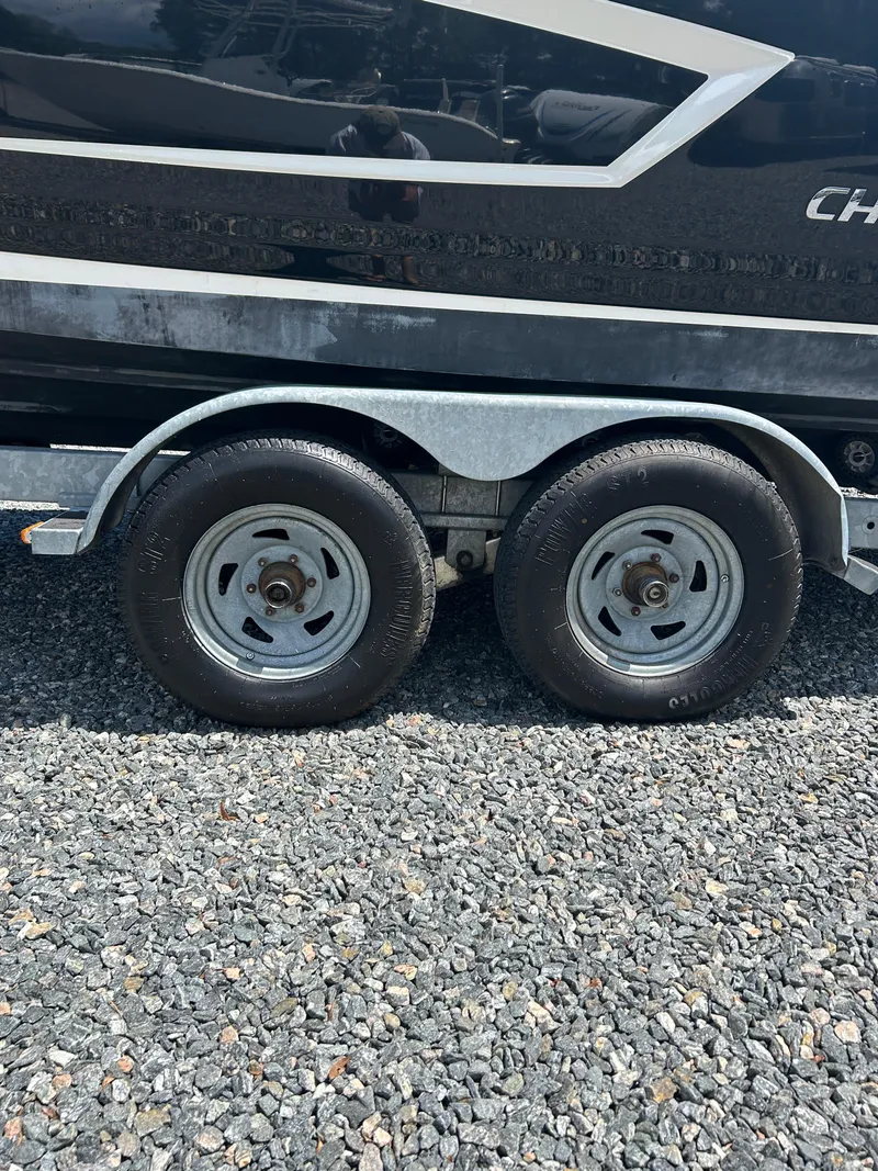 Slide: The Image of Trailer wheels of a 2016 Chaparral 257 SSX boat on gravel surface. - 8