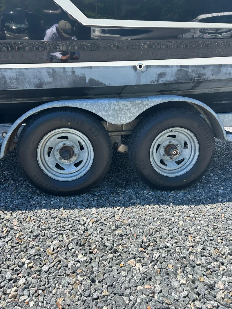 Slide: The Image of 2016 Chaparral 257 SSX trailer wheels on gravel surface. - 9