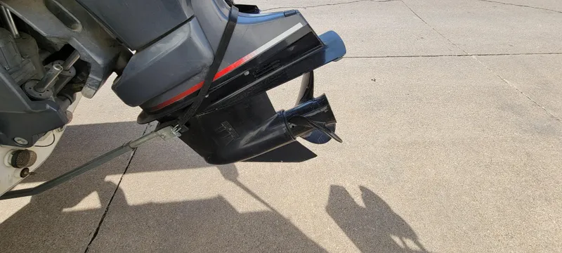 Slide: The Image of Outboard motor of a 2004 Sylvan F 1800 AVENGER on a concrete surface. - 10