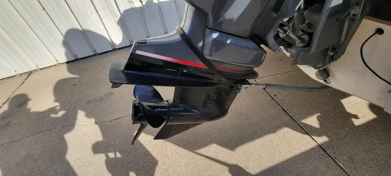 Slide: The Image of 2004 Sylvan F 1800 AVENGER boat motor and propeller on concrete surface. - 11