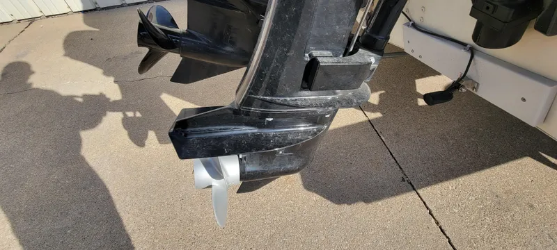 Slide: The Image of Outboard motor of a 2004 Sylvan F 1800 AVENGER boat on concrete surface. - 12