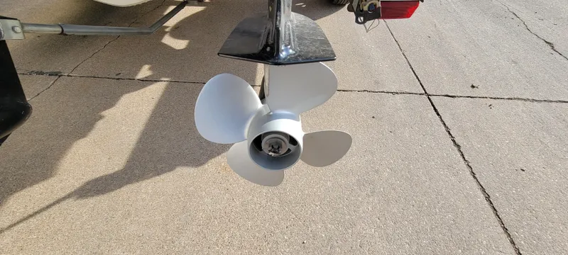 Slide: The Image of Propeller of a 2004 Sylvan F 1800 AVENGER boat on a concrete surface. - 23