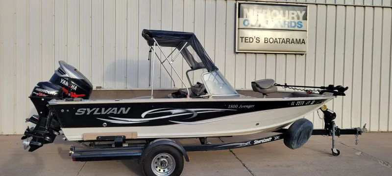 Slide: The Image of 2004 Sylvan F 1800 Avenger boat on trailer, parked outside dealership. - 24