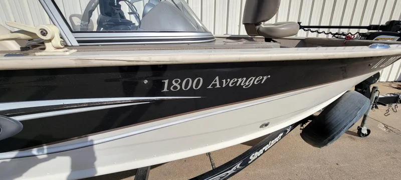 Slide: The Image of 2004 Sylvan F 1800 Avenger boat, black and white exterior, parked on a trailer. - 5