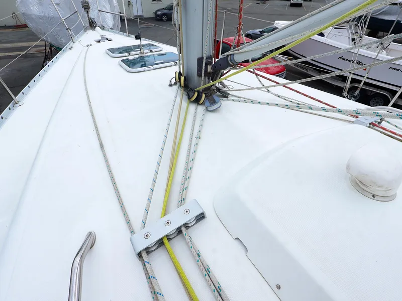 Slide: The Image of Deck view of a 1999 Beneteau 361 sailboat, showcasing rigging and mast details. - 12