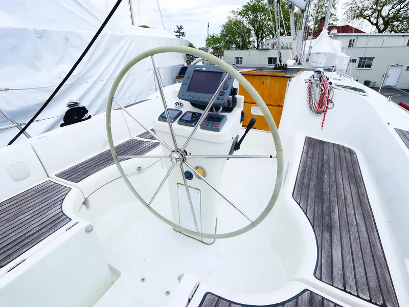 Slide: The Image of Cockpit of 1999 Beneteau 361 sailboat with steering wheel and navigation instruments. - 13