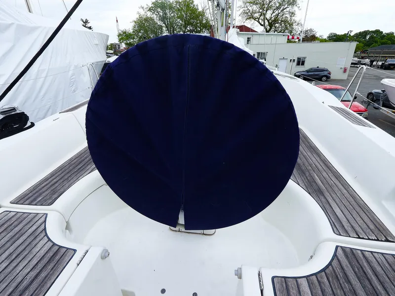 Slide: The Image of 1999 Beneteau 361 sailboat cockpit with covered steering wheel, featuring teak decking. - 16