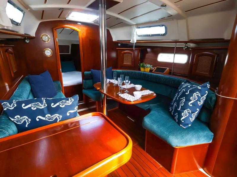 Slide: The Image of Luxurious interior of 1999 Beneteau 361 yacht with elegant wood finish and cozy seating. - 18