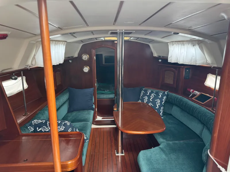 Slide: The Image of Interior of 1999 Beneteau 361 sailboat with wood finish and teal seating. - 19