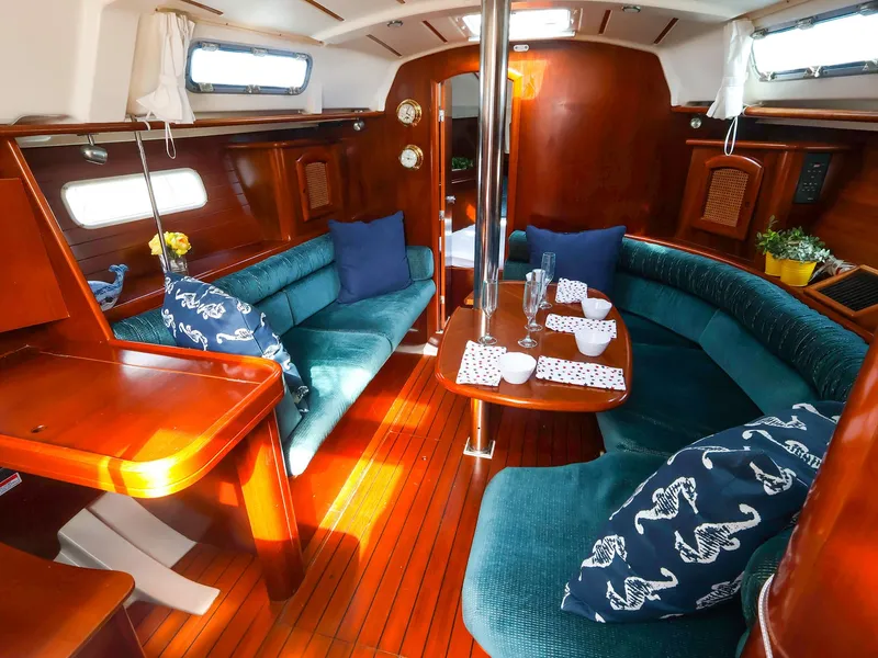 Slide: The Image of Interior of 1999 Beneteau 361 sailboat with elegant wood finish and cozy seating area. - 20