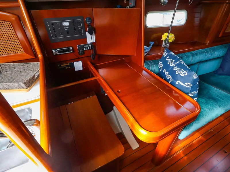 Slide: The Image of Interior of 1999 Beneteau 361 sailboat with wooden table and seating area. - 23