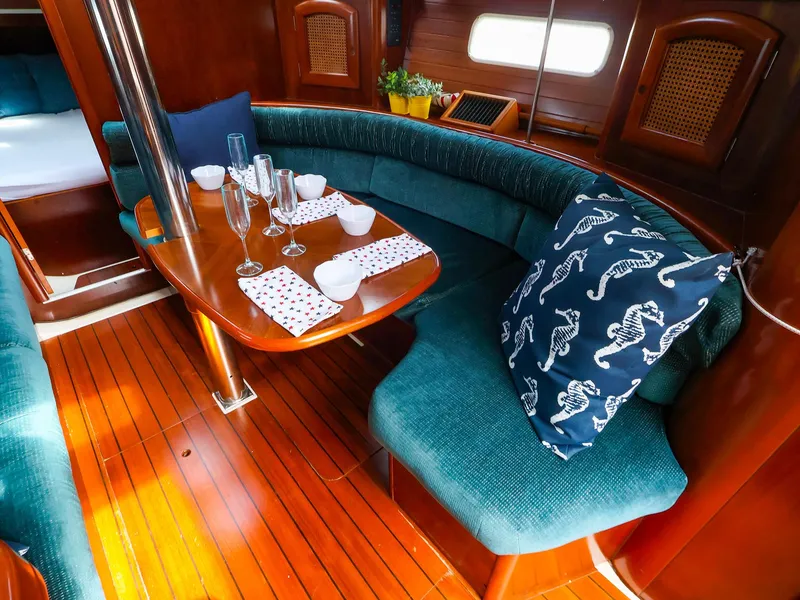 Slide: The Image of Interior of 1999 Beneteau 361 yacht with elegant dining area and plush seating. - 24