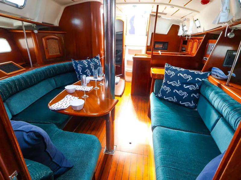 Slide: The Image of Interior of 1999 Beneteau 361 sailboat with elegant wood finish and cozy seating area. - 26