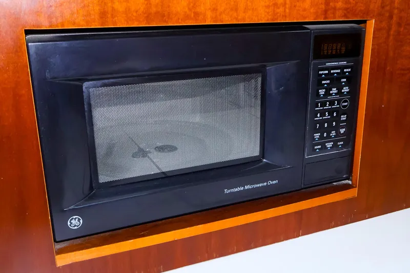 Slide: The Image of Built-in microwave oven on a 1999 Beneteau 361 yacht, featuring a sleek black design. - 28
