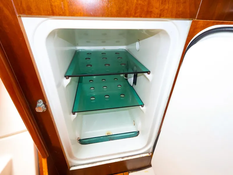 Slide: The Image of Refrigerator interior with glass shelves on a 1999 Beneteau 361 yacht. - 30