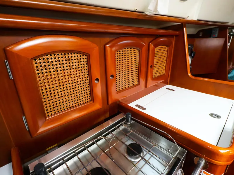 Slide: The Image of Wooden cabinetry and stove in 1999 Beneteau 361 yacht galley. - 34