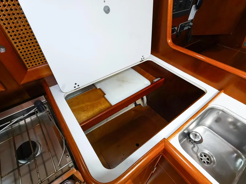 Slide: The Image of Interior view of 1999 Beneteau 361 yacht kitchen with sink and storage space. - 37