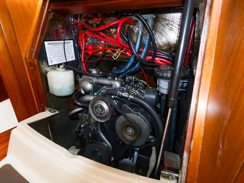 Slide: The Image of Engine compartment of a 1999 Beneteau 361 sailboat, showcasing wiring and components. - 38