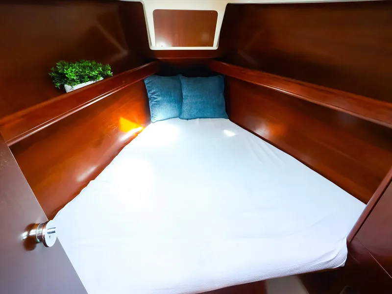 Slide: The Image of Cozy cabin interior of 1999 Beneteau 361 sailboat with bed and pillows. - 39
