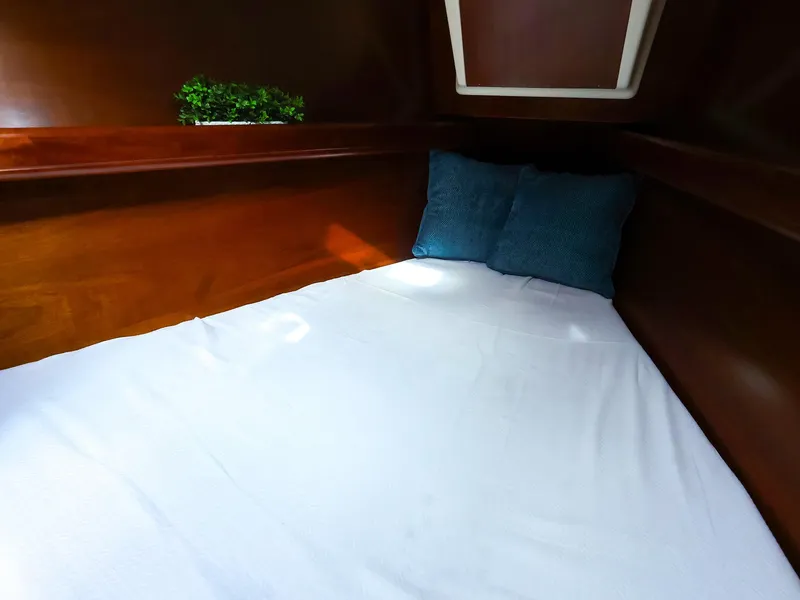 Slide: The Image of Cozy cabin interior of 1999 Beneteau 361 sailboat with pillows and wooden finish. - 41